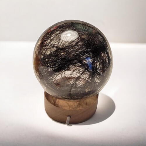 Glass ball with fur and light base